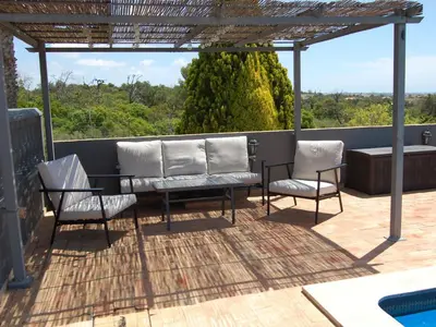 a patio with two chairs and a table and a pool at Holiday Home Villa Monte Alegrete by Interhome in Loulé
