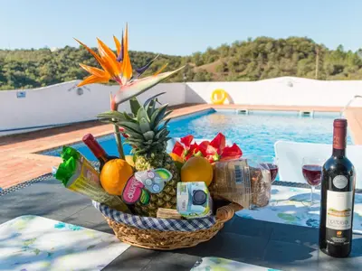 a basket of fruit and vegetables on a table next to a pool at Holiday Home Berghütte Villa Romao by Interhome in Barranco de Apra