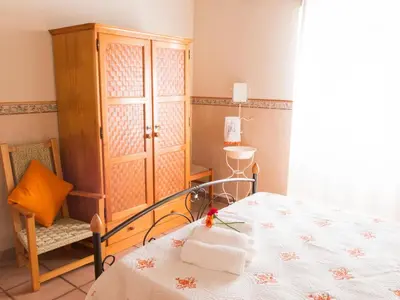 a bedroom with a bed and a cabinet and a chair at Holiday Home Berghütte Villa Romao by Interhome in Barranco de Apra