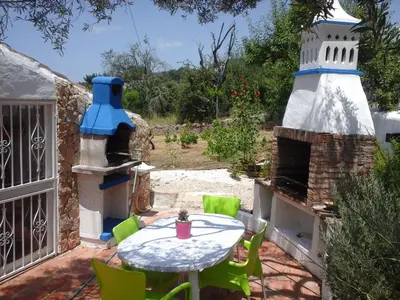 a patio with a table and a lighthouse at Holiday Home Berghütte Villa Romao by Interhome in Barranco de Apra