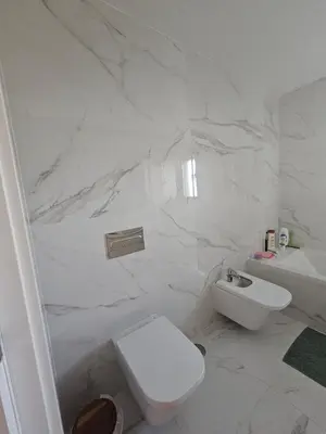 a white bathroom with a toilet and a sink at Apartamento Platinum in Faro