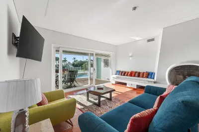 a living room with a blue couch and two chairs at Casa Mimosa in Vale do Lobo