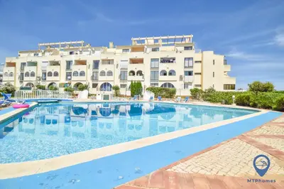 a large swimming pool in front of a building at Vitoria 1 by MTPhomes in Albufeira
