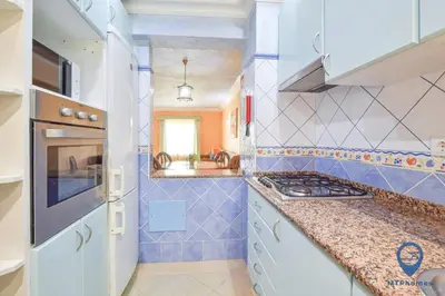 a kitchen with blue and white tiled walls and counters at Vitoria 1 by MTPhomes in Albufeira