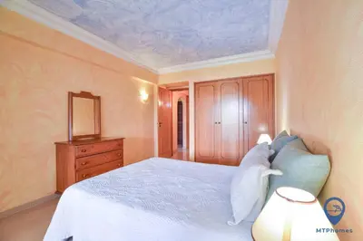 a bedroom with a bed and a dresser and a mirror at Vitoria 1 by MTPhomes in Albufeira