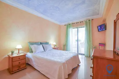 a bedroom with a large bed and a window at Vitoria 1 by MTPhomes in Albufeira