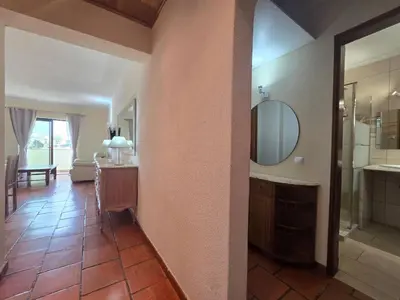 a bathroom with a sink and a mirror on a wall at Vitoria 2 by MTPhomes in Albufeira