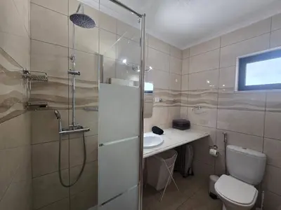 a bathroom with a shower and a toilet and a sink at Vitoria 2 by MTPhomes in Albufeira