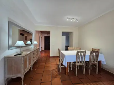 a dining room with a white table and chairs at Vitoria 2 by MTPhomes in Albufeira