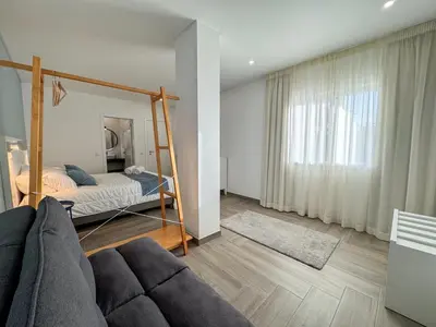 a living room with a bed and a couch at Villa Nova En-suite luxury, private pool, sea view in Albufeira