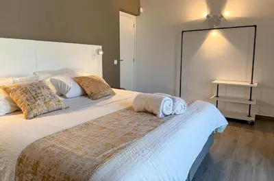 a bedroom with a large bed with towels on it at Villa Nova En-suite luxury, private pool, sea view in Albufeira