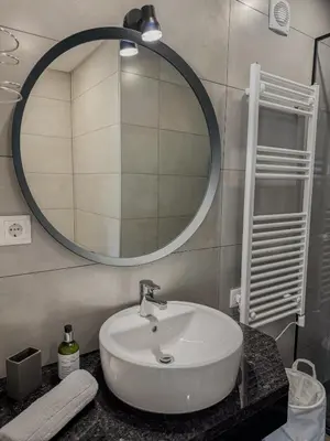 a bathroom with a white sink and a mirror at Villa Nova En-suite luxury, private pool, sea view in Albufeira