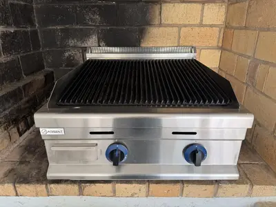a grill sitting next to a brick wall at Villa Nova En-suite luxury, private pool, sea view in Albufeira