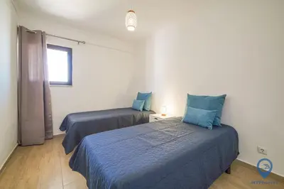 a bedroom with two beds and a window at Bordalo by MTPhomes in Albufeira