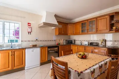 a bedroom with a bed and a dresser and a mirror at Villa Fatima by Villa Select in Galé