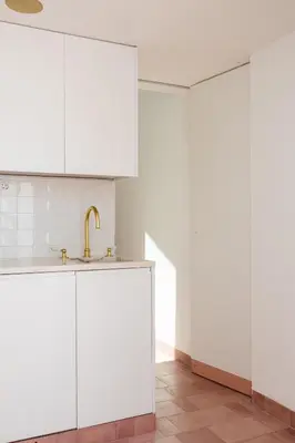 a kitchen with white cabinets and a sink at Casa 1923 by MY CHOICE in Faro