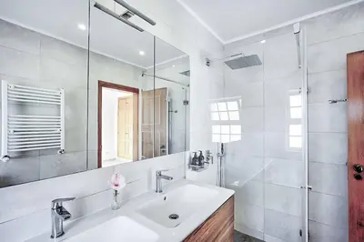 a bedroom with two beds and a chair and a window at Zen Balaia in Olhos de Água