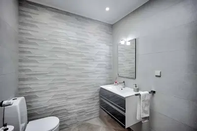 a bathroom with a toilet and a sink and a window at Zen Balaia in Olhos de Água
