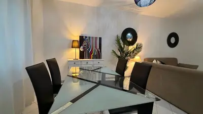 a desk with a lamp and a picture on it at Maple Apartment in Albufeira