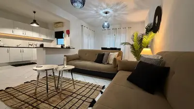 a living room with a couch and a table at Maple Apartment in Albufeira