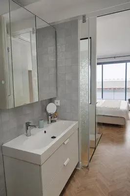 a bathroom with a sink and a mirror and a bed at Elegant City Center Loft in Faro