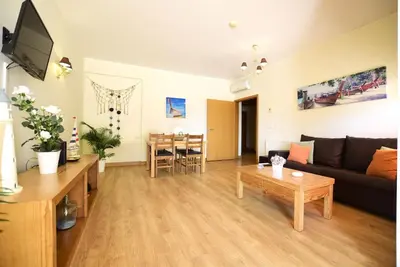 a living room with a couch and a table at Marina Heaven TatiHomes RC in Albufeira