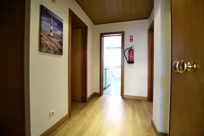 a hallway with an open door and a hallway with at Marina Heaven TatiHomes RC in Albufeira