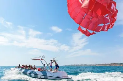 a group of people on a boat with a kite at Marina Sunny Heaven TatiHomes 2 in Albufeira
