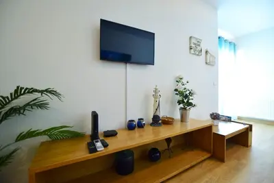 a living room with a television on a wall at Marina Sunny Heaven TatiHomes 2 in Albufeira