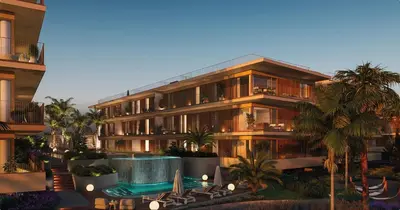 an apartment building with a swimming pool and palm trees at Sweet Horizon in Quarteira