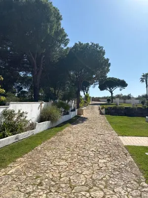 a house with a car parked in the driveway at Villa Levira with private Pool in Quarteira
