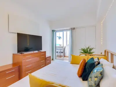 a living room with a couch and a tv at AL - Apartamento Wave 7 in Quarteira