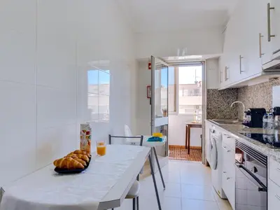a kitchen with a table with a bowl of bread on it at AL - Apartamento Wave 7 in Quarteira