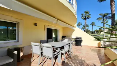 a living room with a couch and a flat screen tv at Villa Golf Gardens - Cleverdetails, Vilamoura in Vilamoura