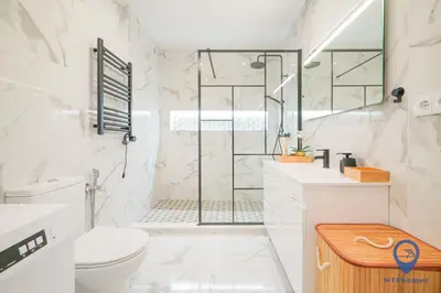 a white bathroom with a shower and a toilet at Palmeiras by MTPhomes in Albufeira