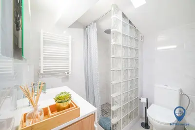 a white bathroom with a toilet and a shower at Palmeiras by MTPhomes in Albufeira
