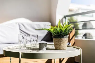 a table with two glasses and a potted plant on it at Luxury Apartment Salgados Village in Guia