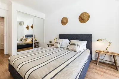 a bedroom with a large bed and a mirror at Luxury Apartment Salgados Village in Guia