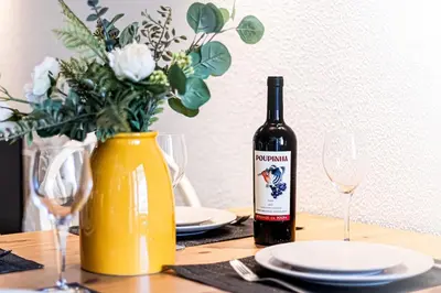 a bottle of wine sitting on a table with glasses at Luxury Apartment Salgados Village in Guia