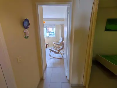 a hallway with a room with two chairs in it at Algarve, cozy T1plus1 apartment in the centre of Quarteira in Quarteira