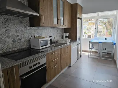 a kitchen with a sink and a microwave at Blife Farensya private apartment in Faro