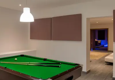 a pool table in a living room with ahibition at Stunning home with nice pool close to the beach in Loulé