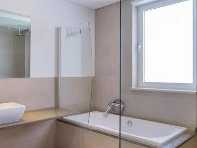 a bathroom with a shower and a sink at Stunning home with nice pool close to the beach in Loulé