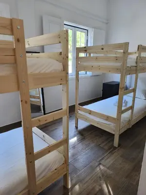 two wooden bunk beds in a room at Chill Spot - Faro Hostel in Faro