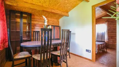 a dining room with a wooden table and chairs at Casa Donis 2021 in Albufeira