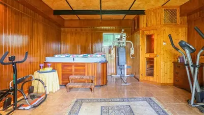 a room with a gym with a tub and exercise equipment at Casa Donis 2021 in Albufeira