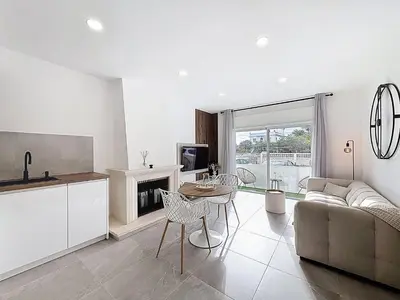 a kitchen and living room with a couch and a table at Albufeira prime stay 2 in Albufeira