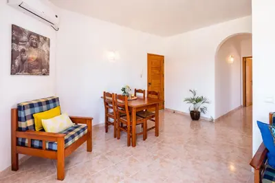 a living room with a dining room table and chairs at Apartamentos Casa Brito, Boliqueime by AlgarveBlossom in Boliqueime