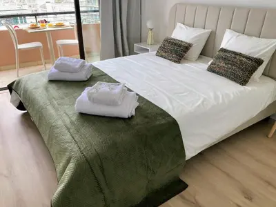 a bedroom with a large bed with towels on it at Apartamento T2 Moderno no Centro de Faro - ML - Market Tower in Faro