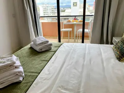 a hotel room with a bed with towels on it at Apartamento T2 Moderno no Centro de Faro - ML - Market Tower in Faro